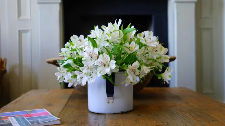 Fresh flowers on a table beside a handmade Mother's Day card