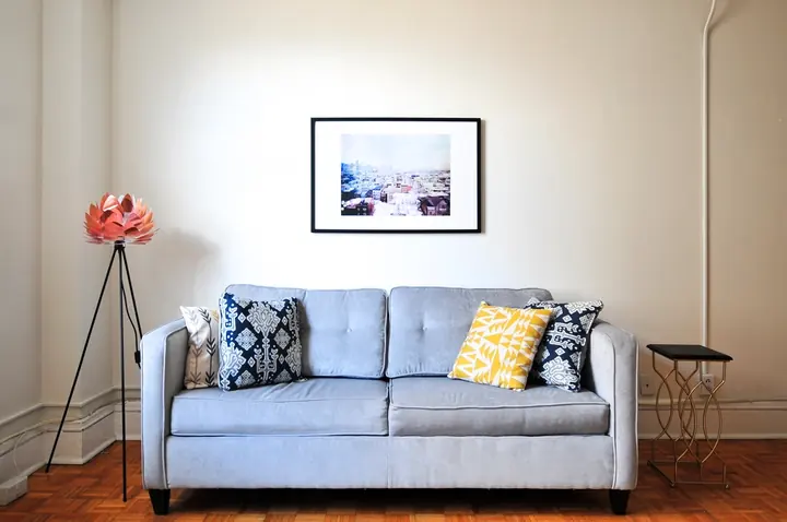 Living room with a blue sofa against softly painted walls