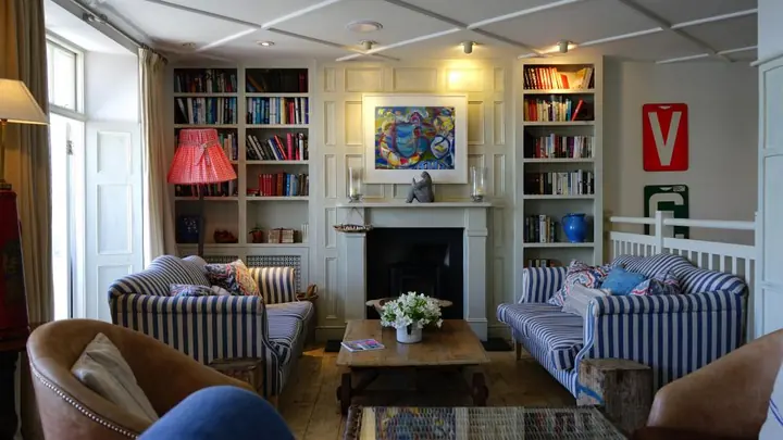 Cozy styled shelves with vases, candles, books, and small plants
