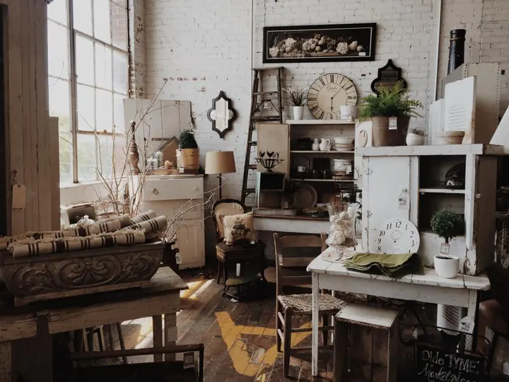 Painted vintage dressers and chairs lined up in a secondhand furniture shop